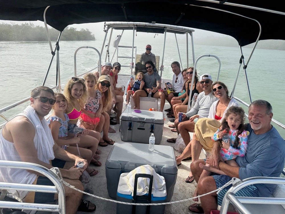 Smiling multi-generational family aboard a Sand Dollar private pontoon charter in the Ten Thousand Islands, Marco Island