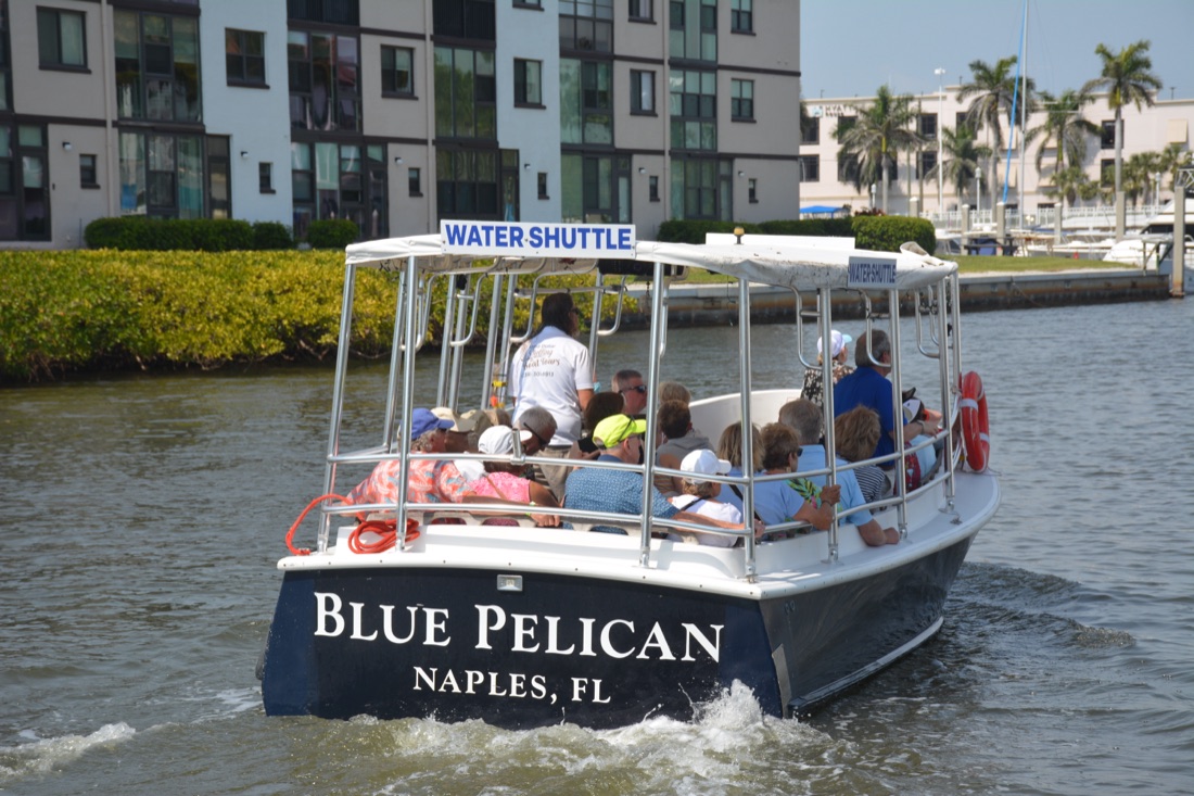 The Blue Pelican Naples Water Shuttle full of guests on Naples Bay, Sand Dollar Boat Tours