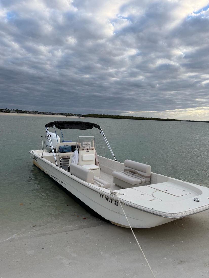 A Sand Dollar Boat Tours center-console runabout on the water in Goodland, Florida