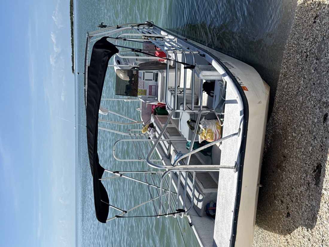 The Island Hopper, a 19-passenger Goodland deck boat with a beach-landing bow, Sand Dollar Boat Tours