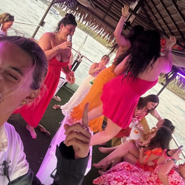Guests celebrating aboard the Sand Dollar tiki boat in Naples, Florida