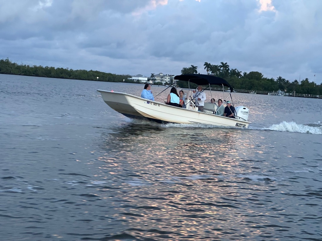 A small private group cruising a Sand Dollar center console boat on a golden sunset waterway near Marco Island, Florida