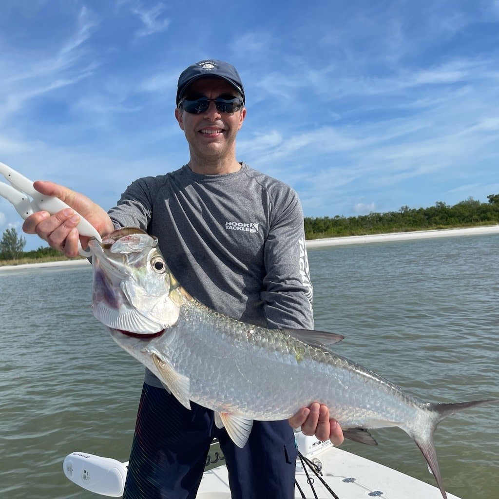 A guest fighting a tarpon on a Sand Dollar fishing charter out of Naples and Marco Island