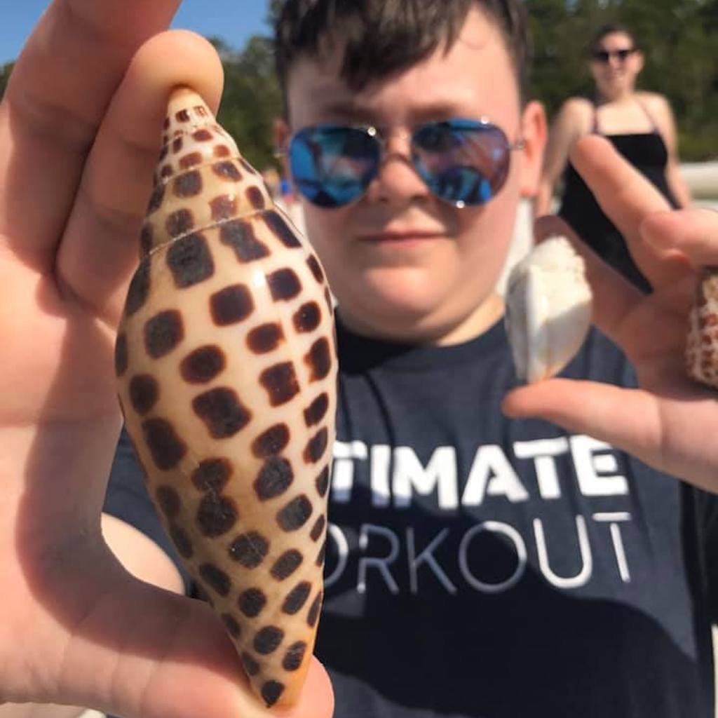 Guest holding shells found on a Naples-area barrier island beach
