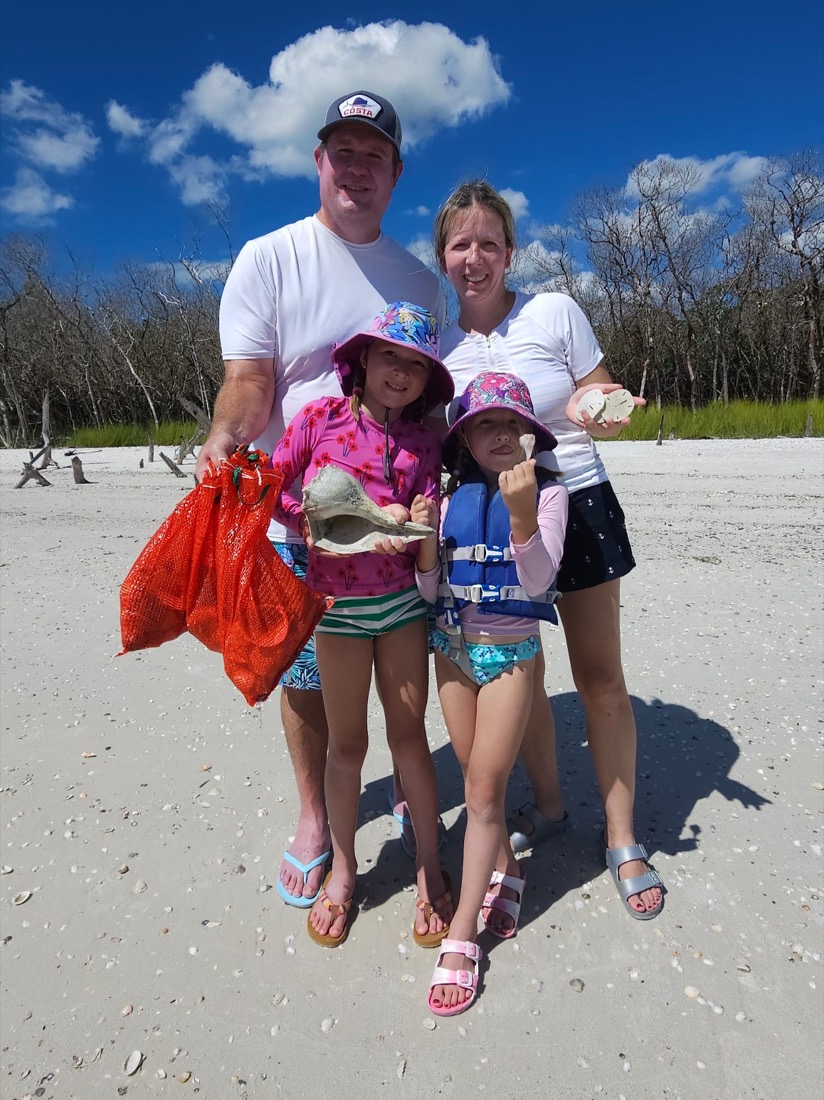 A family holding shells they found on a remote island beach near Marco Island, Florida