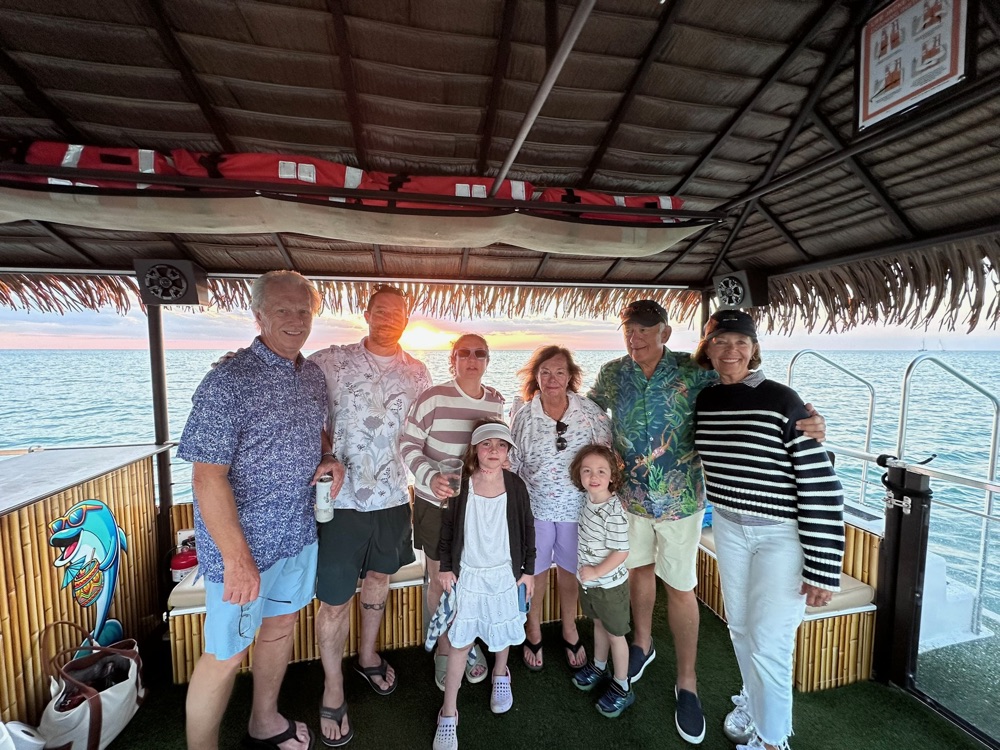 A multigenerational family group on the Sand Dollar tiki boat at sunset near Marco Island, Florida