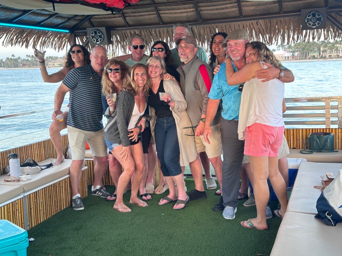 Happy guests celebrating aboard the Sand Dollar tiki boat tour near Naples, Florida