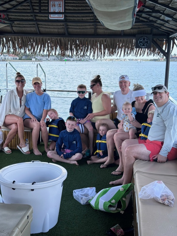 Toddlers safe and shaded aboard the family-friendly tiki boat
